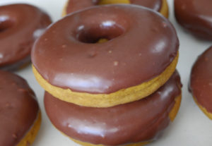 delicious pumpkin doughnuts with chocolate glaze